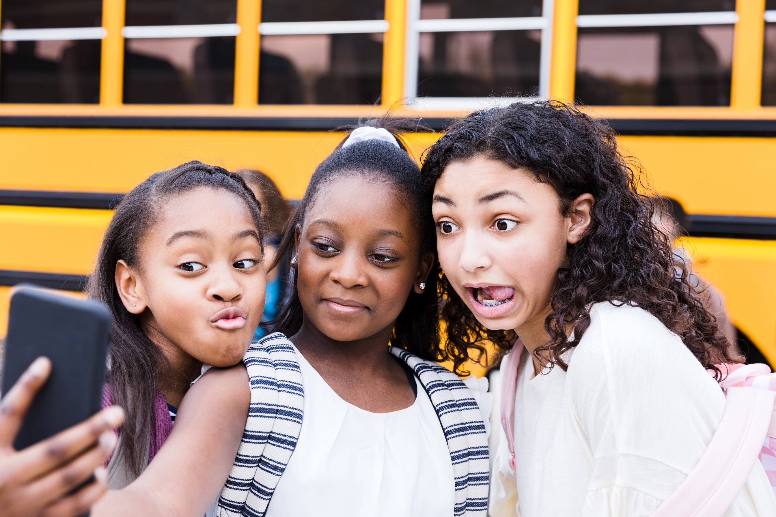 Cute tweens taking selfie